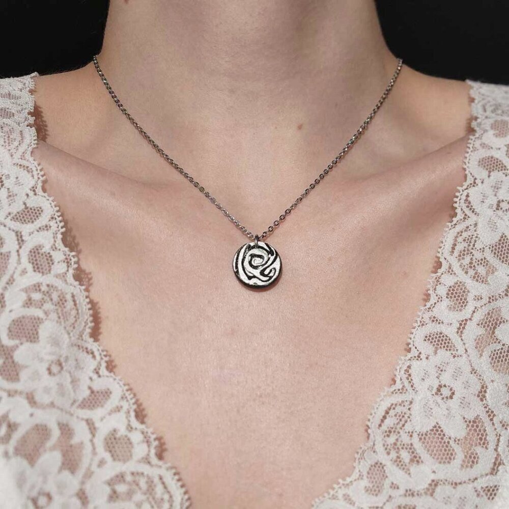 Gothic abstract hypnosis swirly necklace with a small silver chain